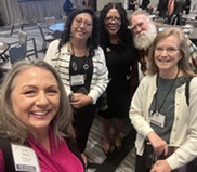 Group of 4 women and one man take selfie