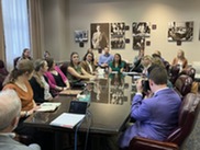 A group of students sitting around a conference table