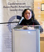 Nichole Espineli speaking at a podium