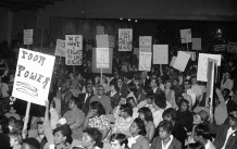 Crowd of people carrying signs