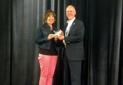 Photo: Assistant to the Secretary for Rural Development Anne Hazlett presents Oregon State Director John Huffman with award