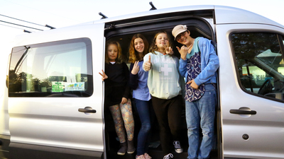 Students enrolled in the Neighbors for Kids after-school program in the nonprofit's new van