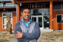 Photo of a person in front of a library