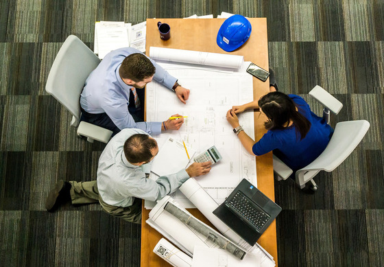 Overhead view of a group conferring around a conference table