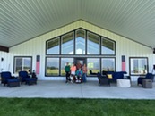 A group sits outside a residential care facility.