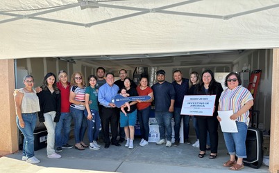 A group of ten families celebrates homeownership month.