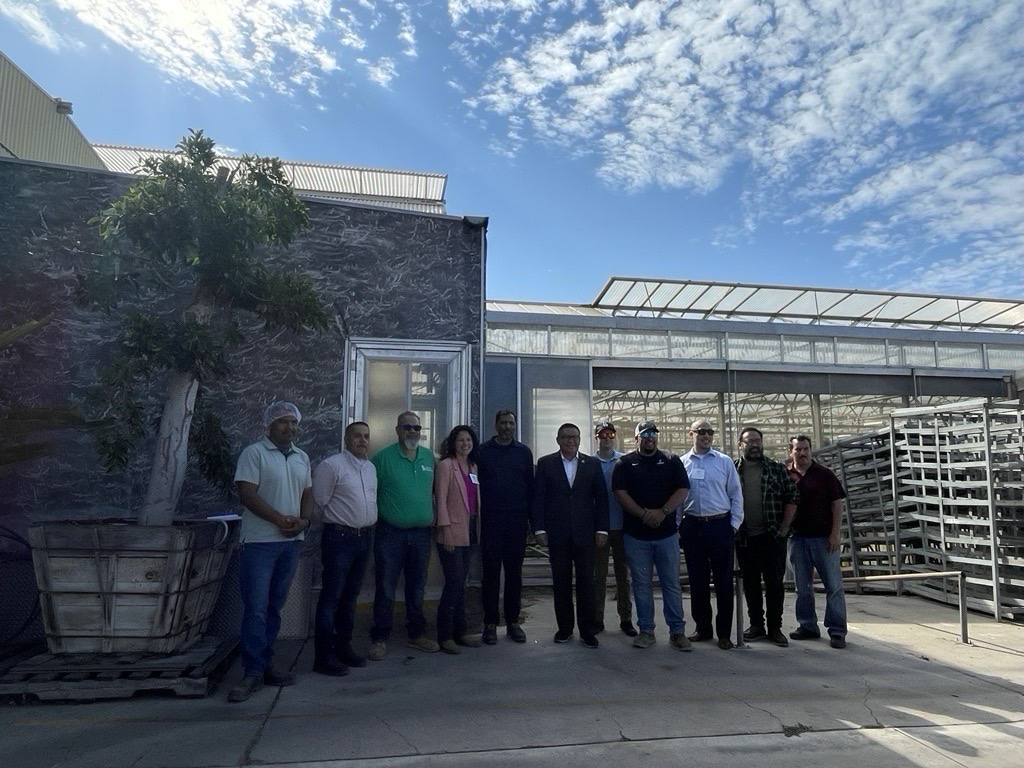 A group stands together to celebrate an energy investment.