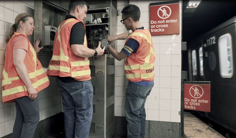 MIT Lincoln Laboratory personnel install support equipment in one of the testbed cabinets in the NYC subway.