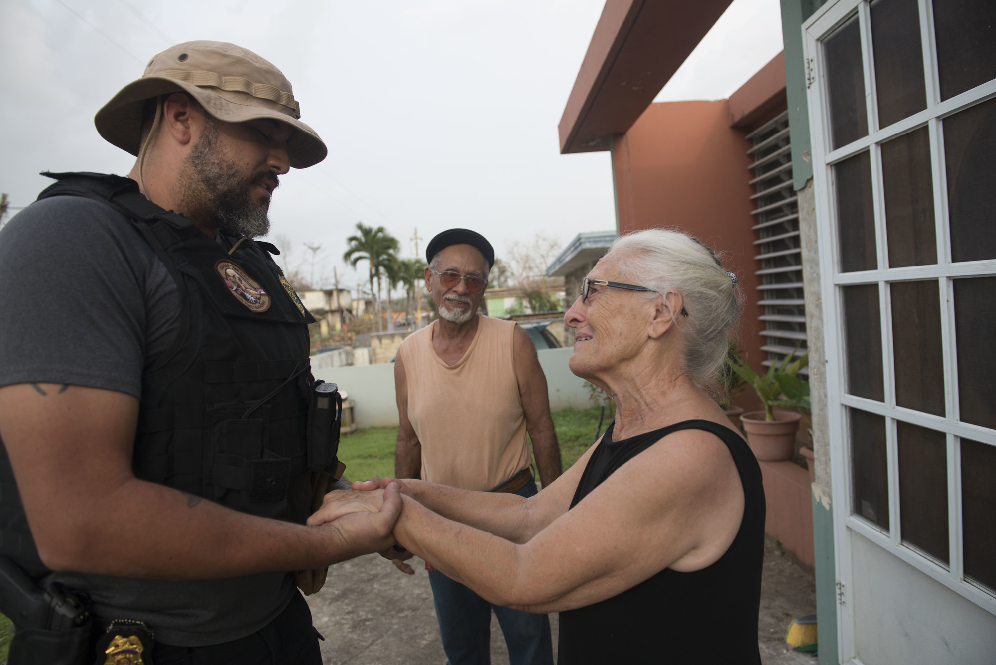 Maria Gonzolas, a resident of Puerto Rico, embraces a Coast Guard Investigative Service agent