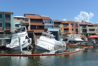 Crews work to dewater storm-impacted vessels in Palmas del Mar, Puerto Rico