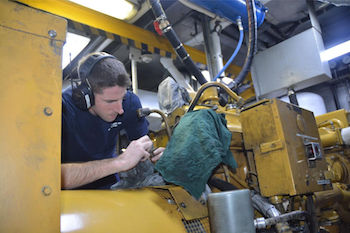 Crewmember repairs diesel generator