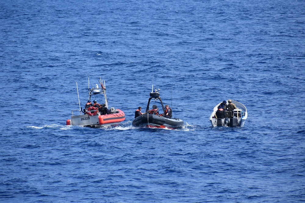 Photo of CGC Steadfast crewmembers inspecting suspected drug trafficking go-fast boat