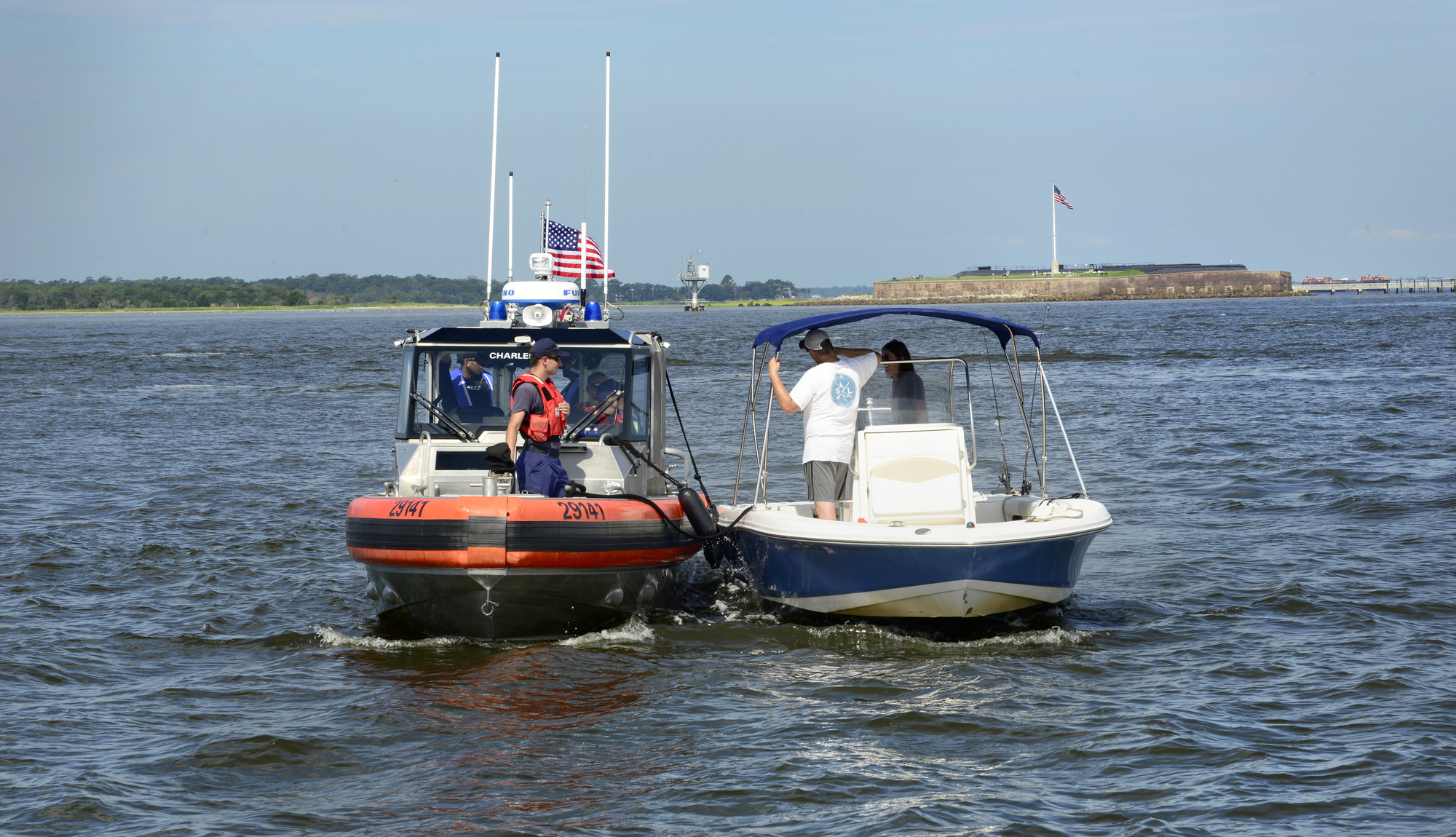 A U.S. Coast Guard response boat stops a recreational boater in the Charleston Harbor, S.C. Aug. 11, 2018, as part of Operation SHRIMP and GRITS, a multi-state and multi-jurisdiction maritime enforcement operation. The name stands for “Save Harbor Reach on Intelligence for Multi-state Partnerships and Guarding Responsible Interests for Target Safety.” One of the objectives of this operation is to unify and coordinate investigative efforts between federal, state and local agency assets. (U.S. Air Force photo by Senior Airman Tenley Long) 