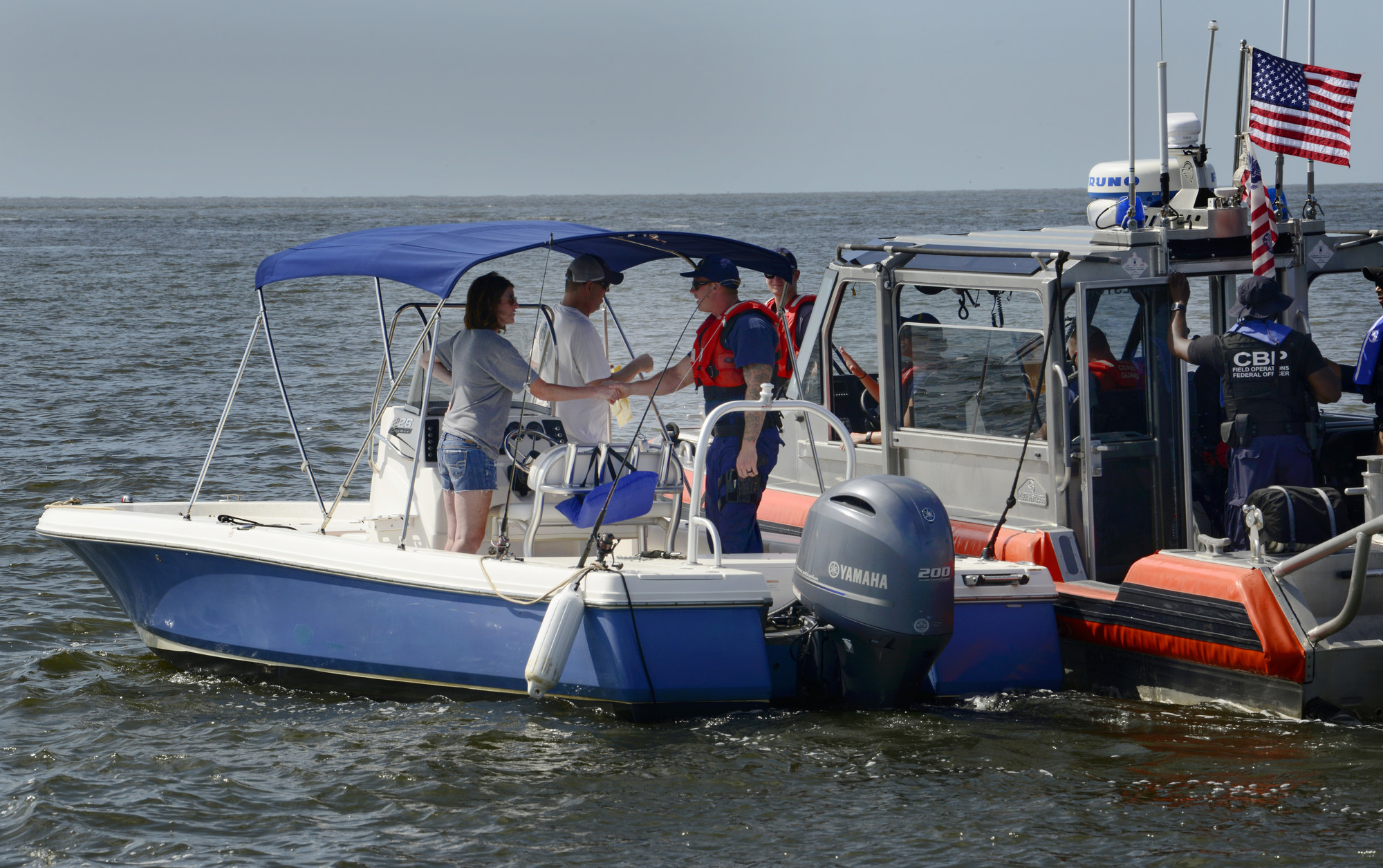 A U.S. Coast Guard response boat stops a recreational boater in the Charleston Harbor, S.C. Aug. 11, 2018, as part of Operation SHRIMP and GRITS, a multi-state and multi-jurisdiction maritime enforcement operation. The name stands for “Save Harbor Reach on Intelligence for Multi-state Partnerships and Guarding Responsible Interests for Target Safety.” The operation targets recreational and commercial vessels transitioning north and south along the Intracoastal Waterway and offshore. (U.S. Air Force photo by Senior Airman Tenley Long)
