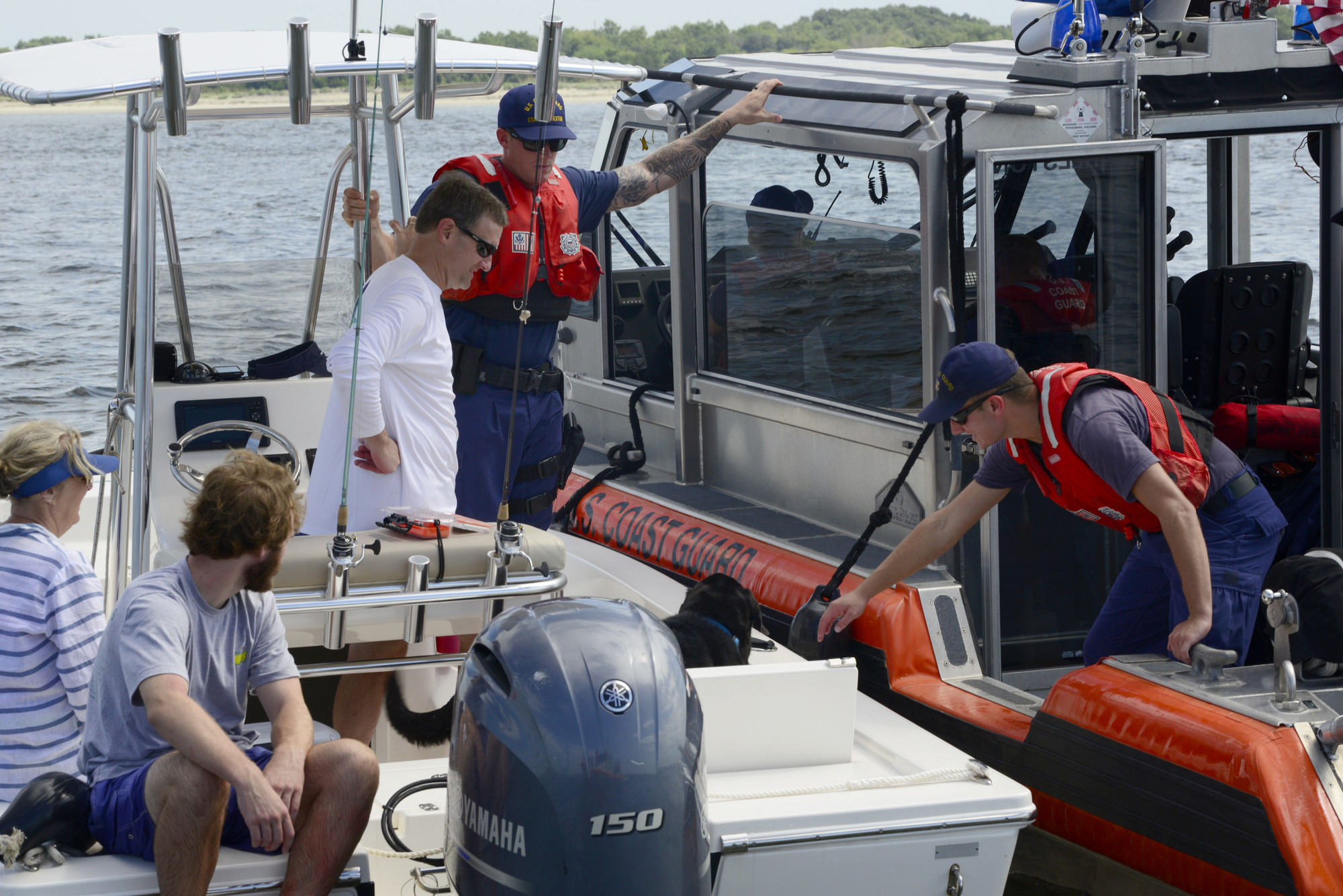 A U.S. Coast Guard response boat stops a recreational boater in the Charleston Harbor, S.C. Aug. 11, 2018, as part of Operation SHRIMP and GRITS, a multi-state and multi-jurisdiction maritime enforcement operation. The name stands for “Save Harbor Reach on Intelligence for Multi-state Partnerships and Guarding Responsible Interests for Target Safety.” The operation targets recreational and commercial vessels transitioning north and south along the Intracoastal Waterway and offshore. (U.S. Air Force photo by Senior Airman Tenley Long) 