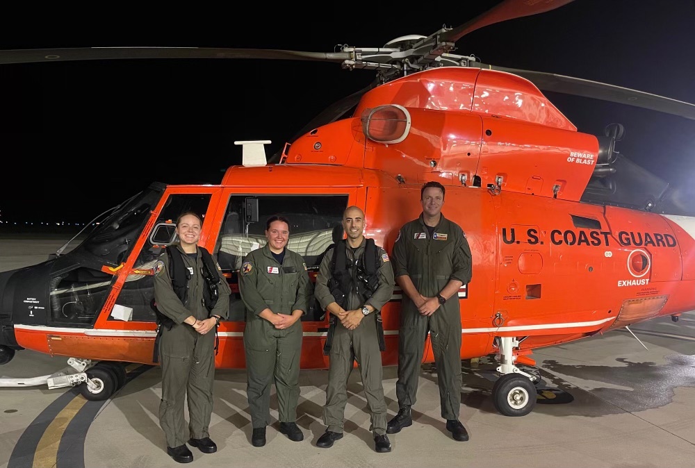 An MH-65 Dolphin helicopter crew from Coast Guard Sector/Air Station Corpus Christi poses for a picture after conducting a successful medevac 18 miles off Corpus Christi, Texas, Aug. 5, 2021. The helicopter crew hoisted an ailing crew member from the liquefied natural gas tanker vessel Iberica Knutsen and transported him to Corpus Christi Medical Center Bay Area. (U.S. Coast Guard photo, courtesy Sector/Air Station Corpus Christi)