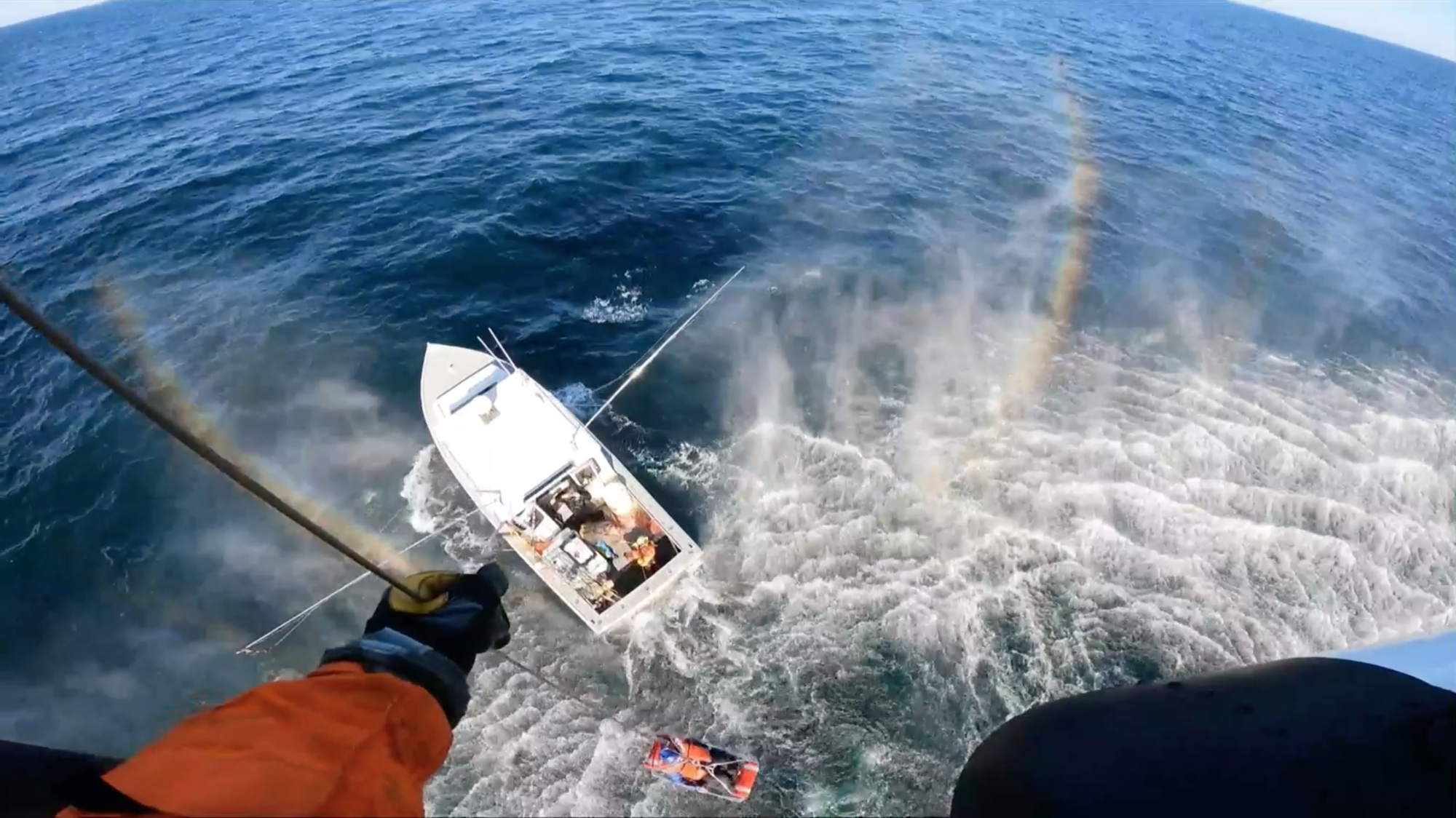 Coast Guard Air Station Cape Cod air crew lifts a sick passenger from a charter vessel