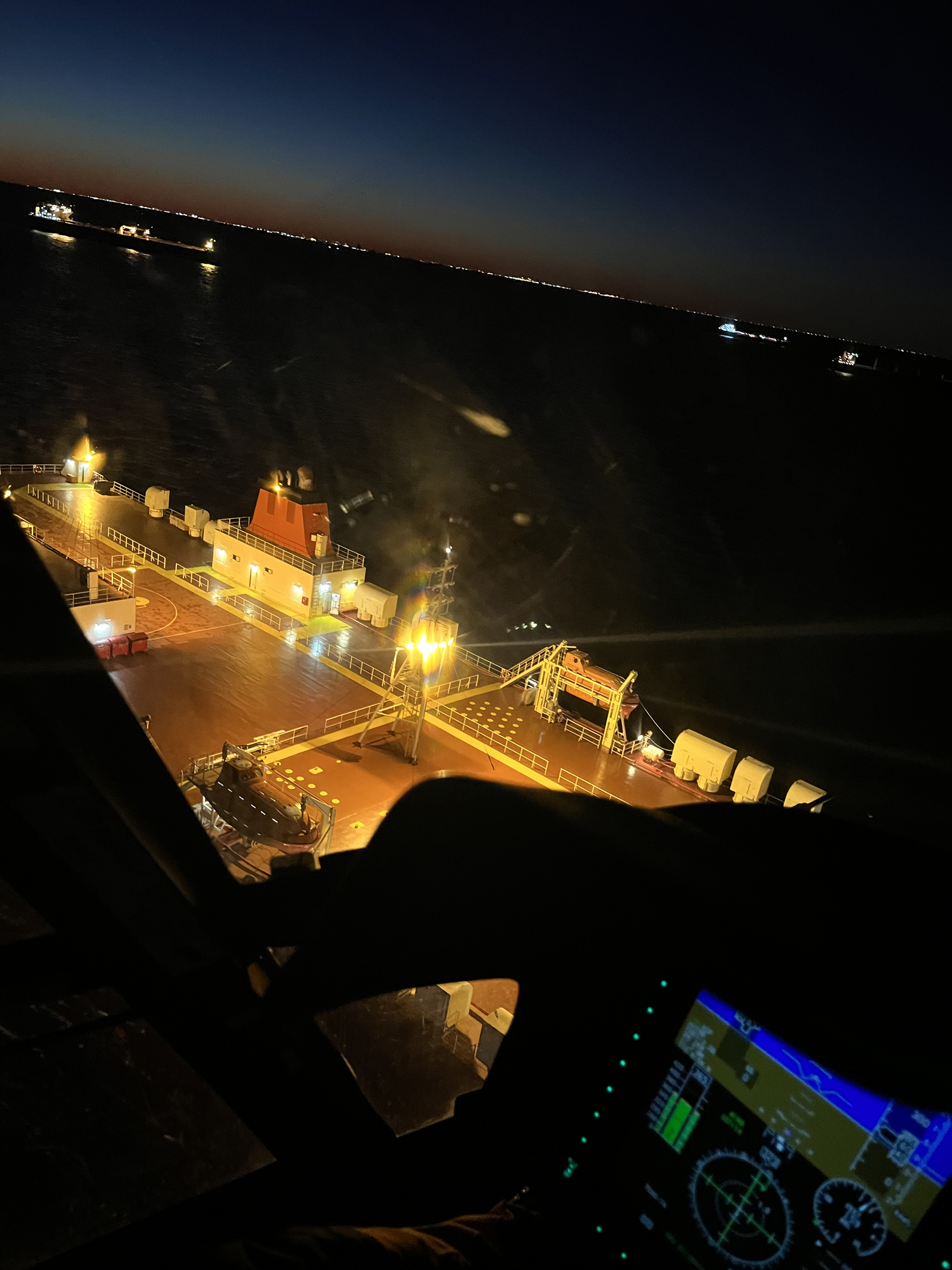 A Coast Guard Air Station Houston MH-65 Dolphin helicopter crew prepares to medevac the captain of the San Martin, a 555-foot roll-on/roll-off cargo ship, who was experiencing symptoms of hypertension and leg swelling near Galveston, Texas, Dec. 14, 2022. The helicopter crew hoisted the captain and transported him to the University of Texas Medical Branch at Galveston. (U.S. Coast Guard photo courtesy, Air Station Houston)