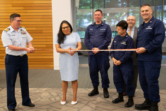 Raffi Freedman-Gurspan prepares to cut a ceremonial ribbon with scissors. 