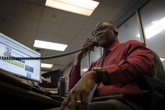 Worker at their workstation on the telephone.