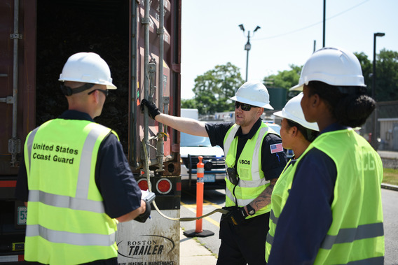 Coast Guard members conduct container inspections.