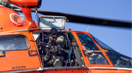 Coast Guard members pilot and operate from a helicopter
