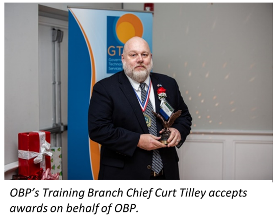 OPB's Training Branch Chief Curt Tilley accepts awards on behalf of OPB