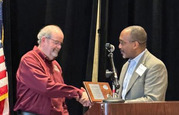 CISA Executive Assistant Director for Emergency Communications, Billy Bob Brown, Jr., presented Mark Buchholz with a certificate of recognition.