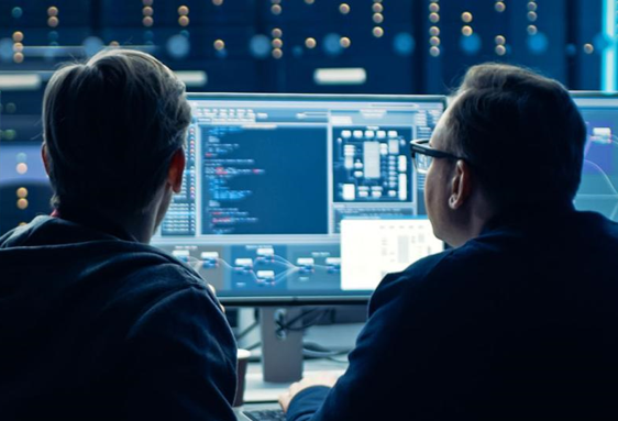 Two men working at computer