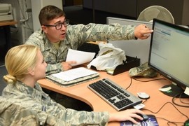 Members of the military work on personal finance at a computer