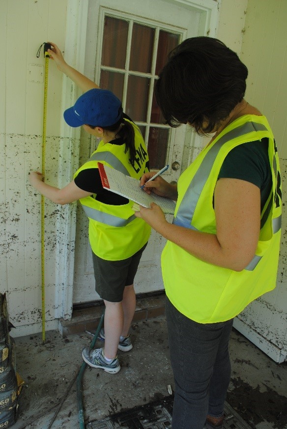 LFMA DRT volunteers collect high-water mark measurements on a flooded house, during the August 2016 flood. 
