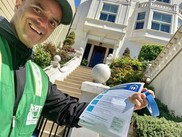 Neighborhood Emergency Response team volunteer passing around COVID-19 flyers in San Francisco. 