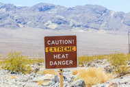 Caution! Extreme Heat Danger sign on the side of a mountain.