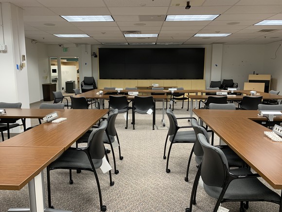 An empty conference room with tables and chairs