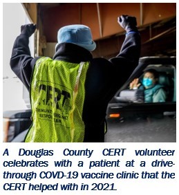 A Douglas County CERT volunteer celebrates with a patient at a drive-through COVD-19 vaccine clinic that the CERT helped with in 2021.