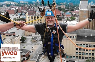 Photo of Brian Farkas Rapelling Down a Building