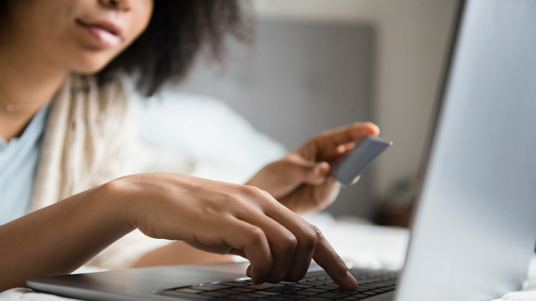 2024 June MFSP Woman holding credit card looking at computer