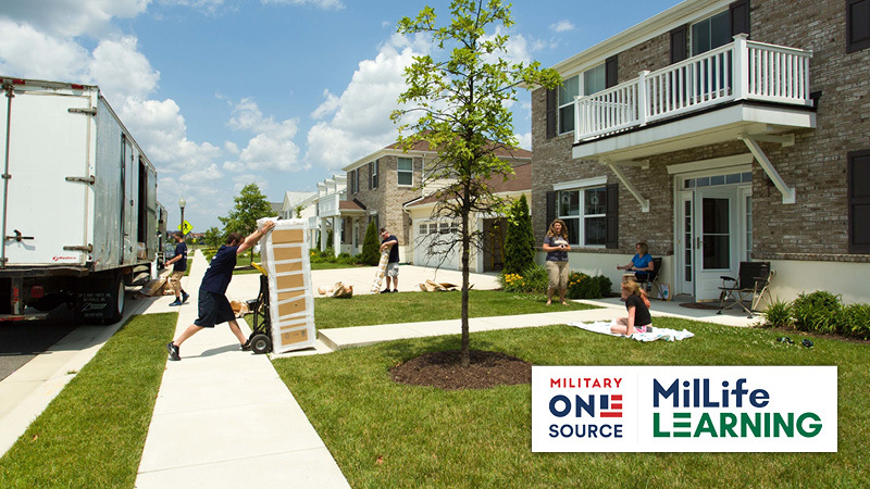 People moving boxes to house