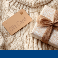 Gift card and present on sweater texture.