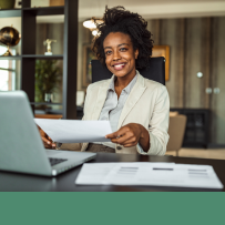 Woman working at laptop and smiling