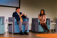Assistant Secretary Katie Jereza sitting and talking with Dr. Michael Howard during a fireside chat