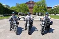 Three USPP personnel pose for a photo on electric motorcycles.