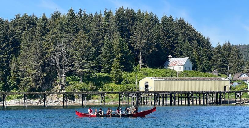 Angoon youth paddling a traditional red cedar dug out canoe.