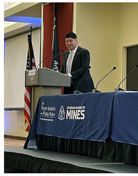 Director Mahroum speaks at podium at the Native American Mining and Energy Sovereignty Symposium[