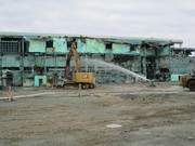 Hanford Site workers finish loading demolition debris from the south side of the Main Processing Facility at the Plutonium Finishing Plant