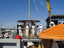 Workers remove a contaminated thermocouple from single-shell tank.