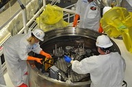 Workers prepare the 20th and final sludge container for shipment at the Hanford Site. 