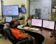 A nuclear chemical operator monitors the performance of the 200 West Pump and Treat Facility from the control room.