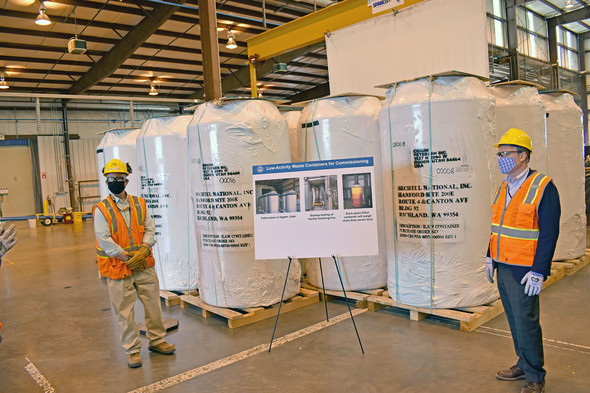 EM chief Ike White (right) saw the first 20 containers that will hold vitrified waste simulant and tank waste.