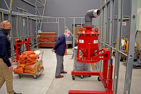 EM chief Ike White (right) ended his visit with a stop at a mock-up of a former plutonium processing laboratory. 